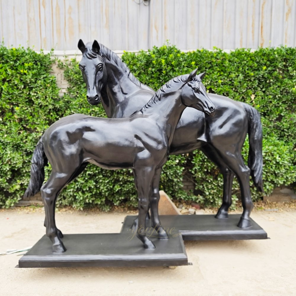 bronze statue of a mare and foal playing