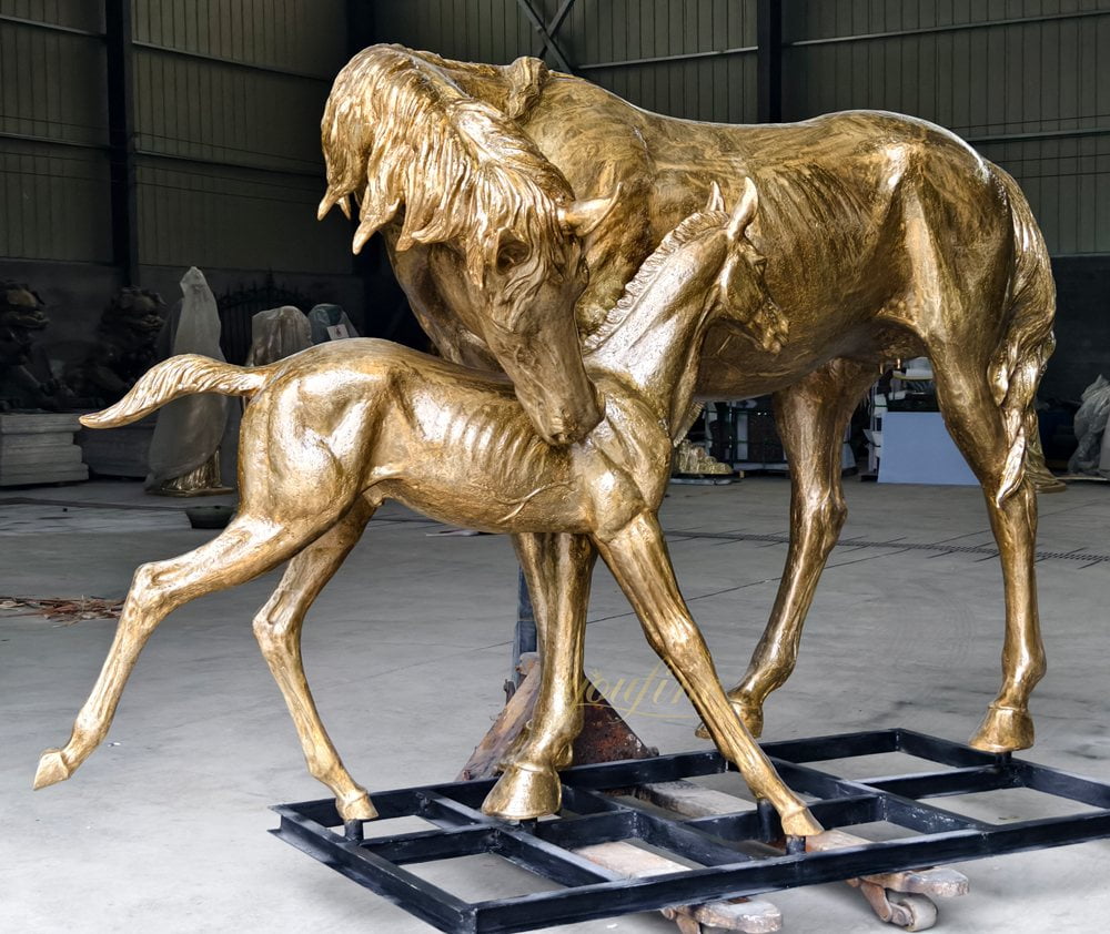 bronze statue of a mare and foal