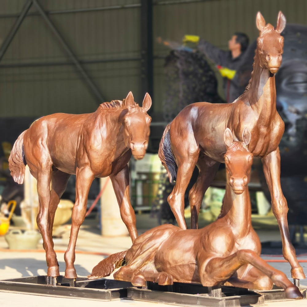 group bronze statue of a mare and foal