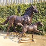 statue of a mare and foal playing