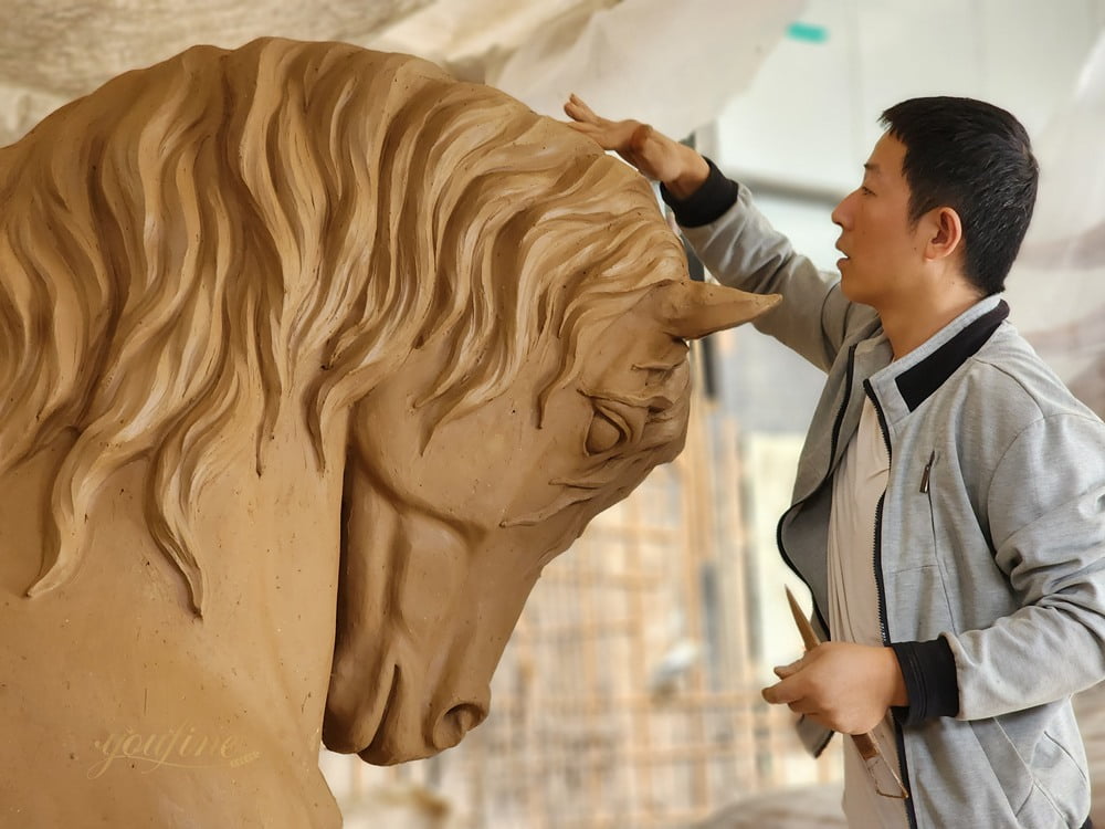 sculptor hand modify life size Friesian horse clay model