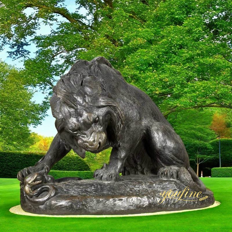 Lifesize lion crushing a serpent