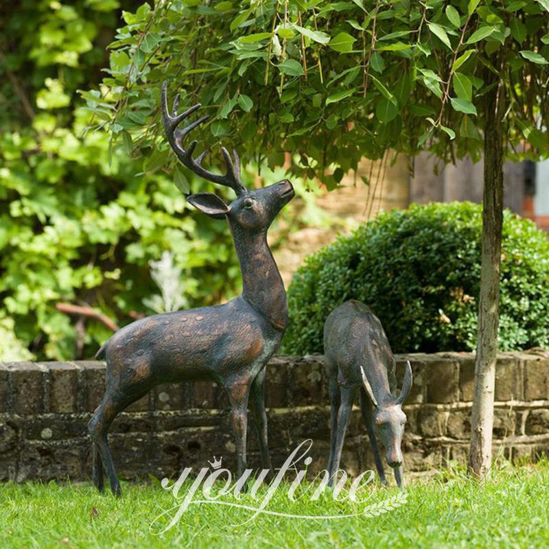 Pair-of-verdi-gris-garden-deer-sculptures-under-a-tree-a
