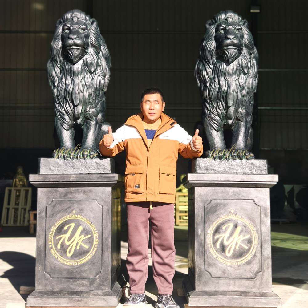Dark green crouching lion sculpture