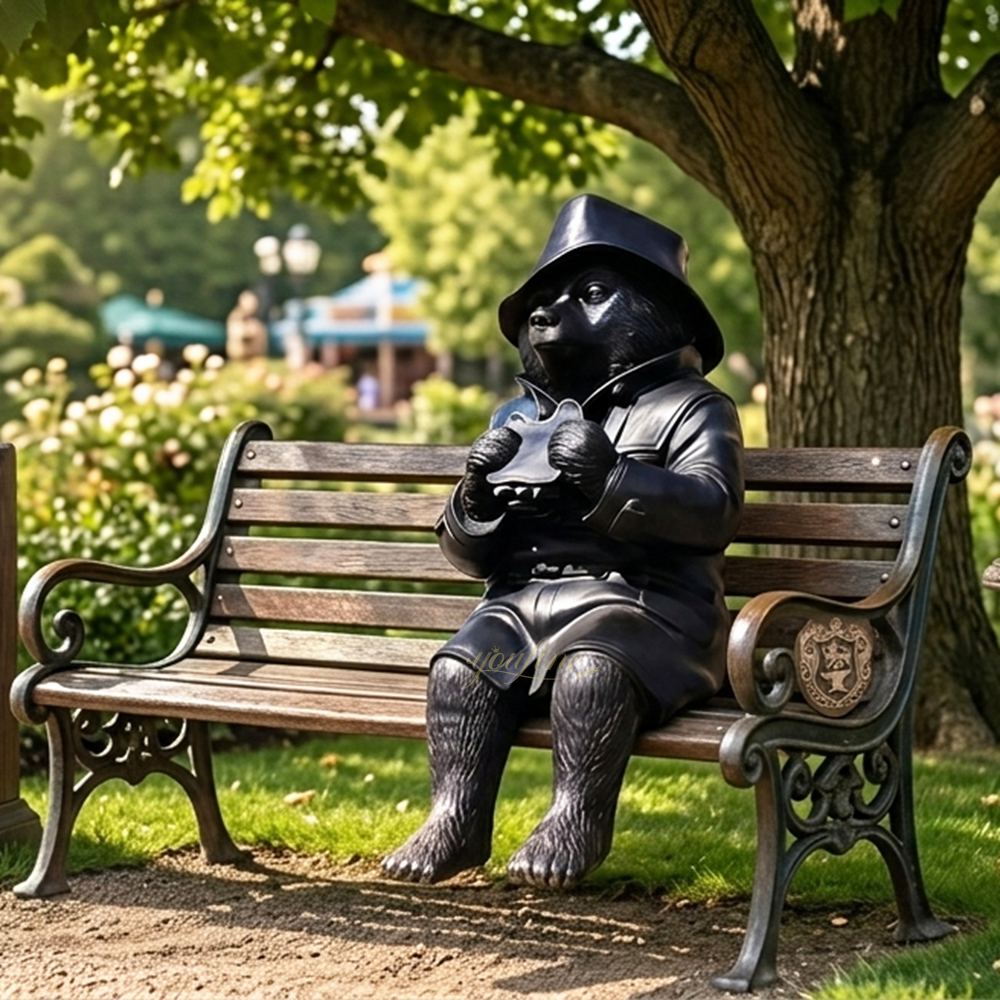 life size bronze paddington bear on wooden bench