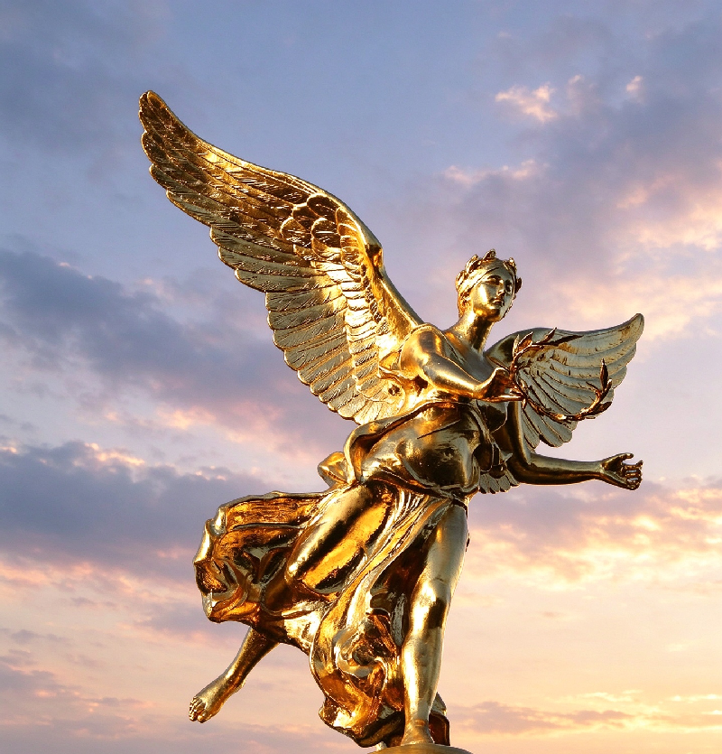 Golden angel statue with spread wings