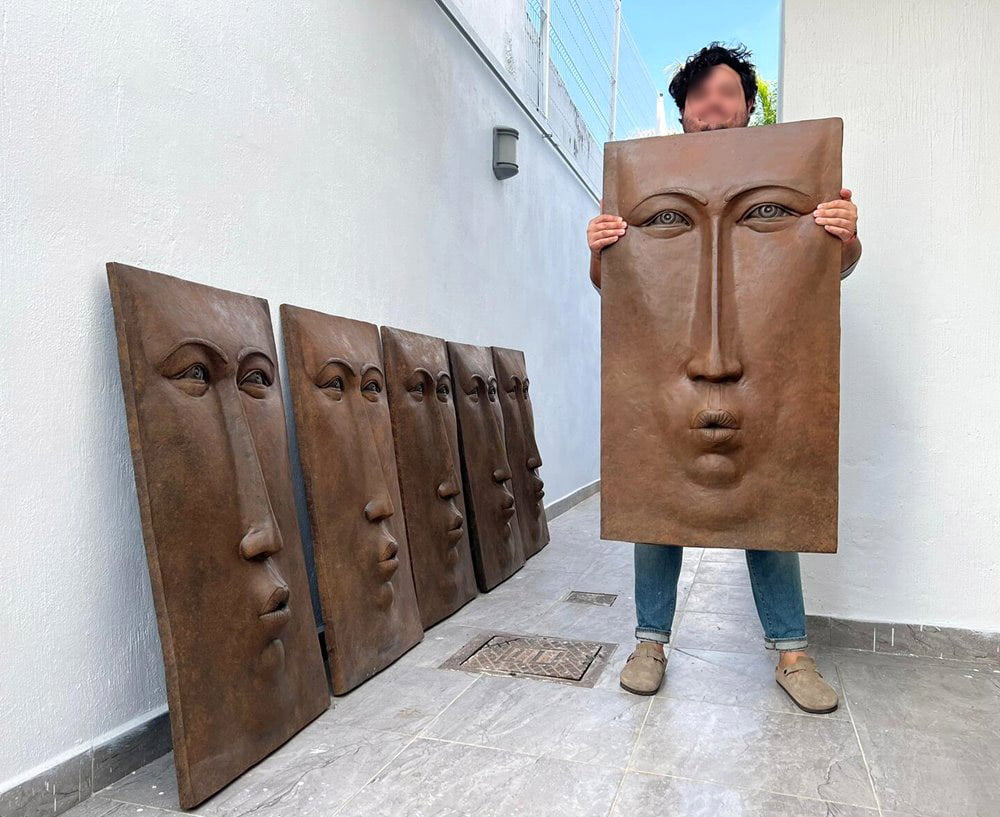 Our customer lifts the heavy bronze sculpture with both hands.