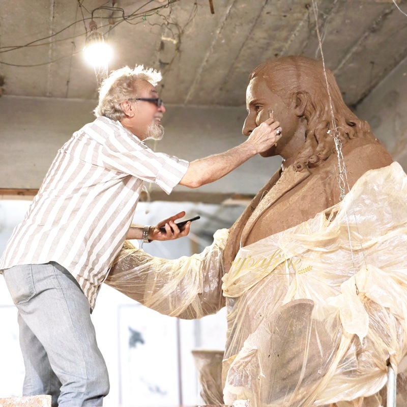 Artist making clay model of bronze poet statue at YouFine foundry