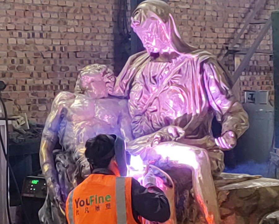 Welding the bronze pieta sculpture