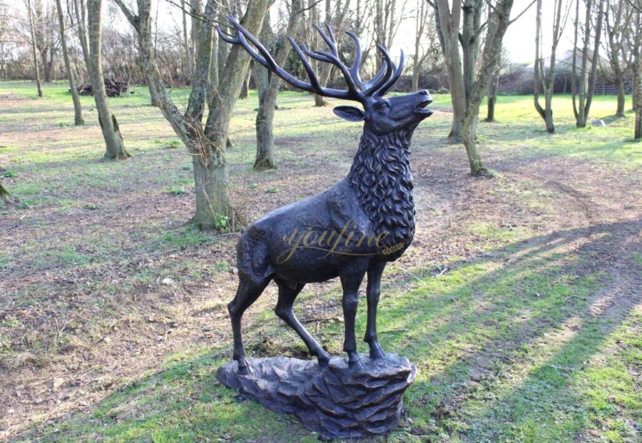 Sculpture of a roaring deer standing on a rock