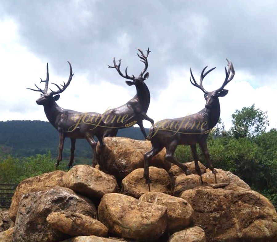 Three bronze elk sculptures standing on the rocks