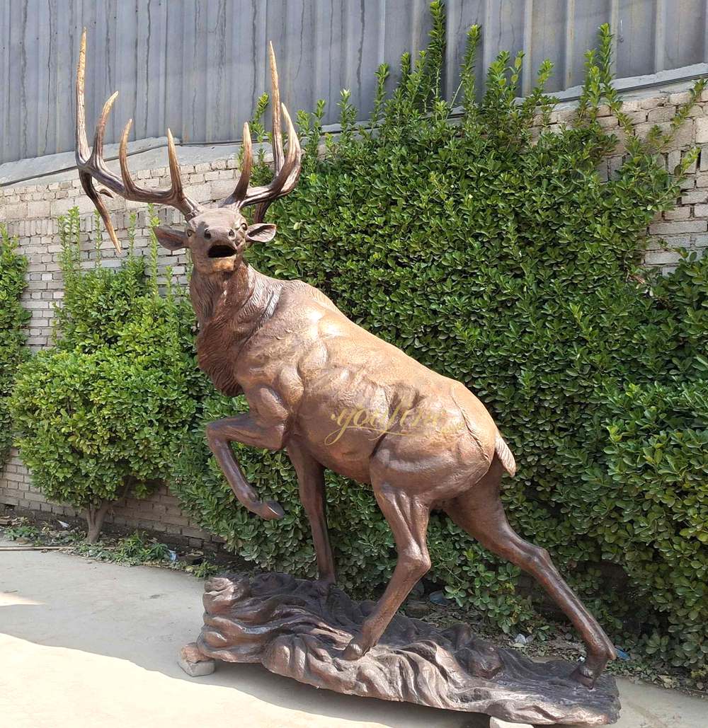 A bronze deer sculpture looking back and roaring