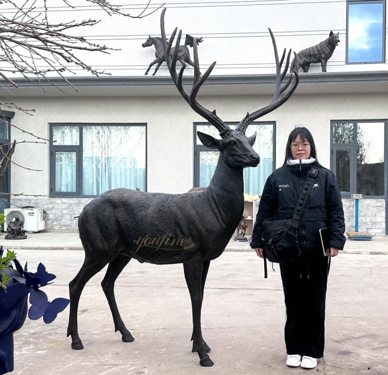 Quality inspectors and bronze deer sculpture