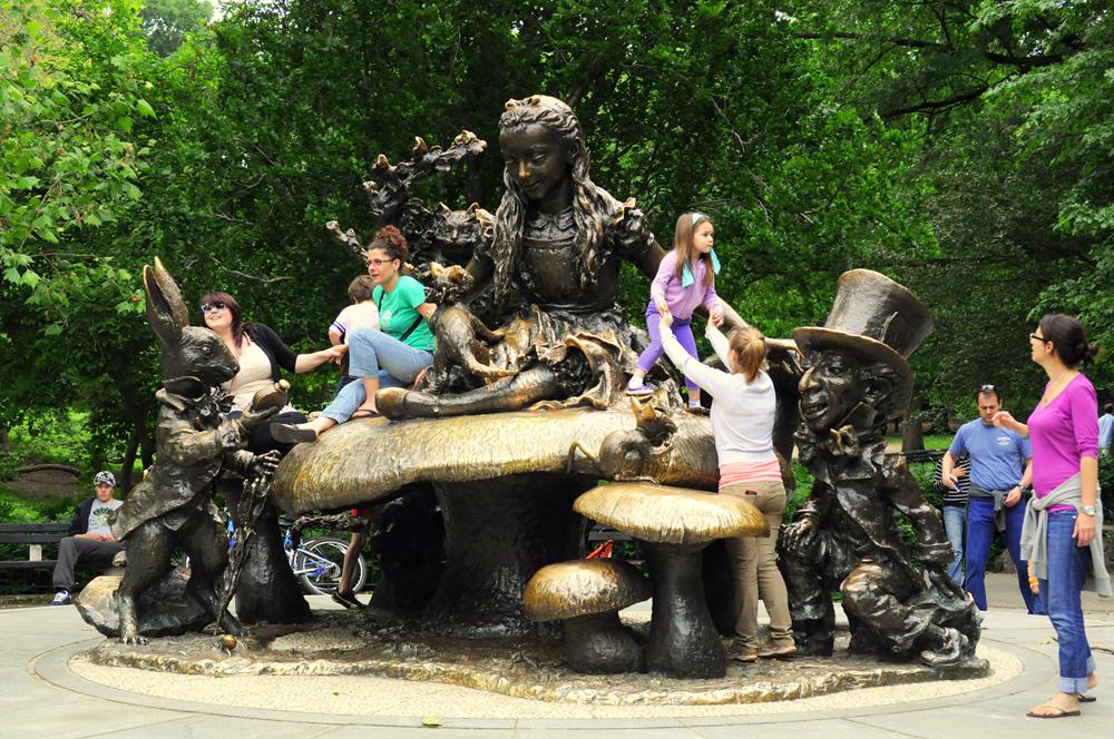 Top 10 Most Popular Bronze Sculptures in Central Park - Blog - 4 Children play on alice in wonderland famous sculpture
