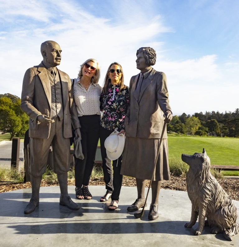 art collector looking at bronze statue