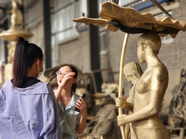 Museum procurement manager visiting YouFine Bronzes Gallery and reviewing art reproduction capabilities