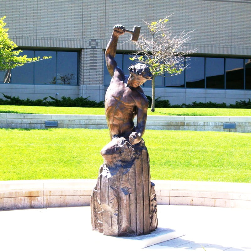 Man Carving Himself Out of Stone for outdoor plaza installation.