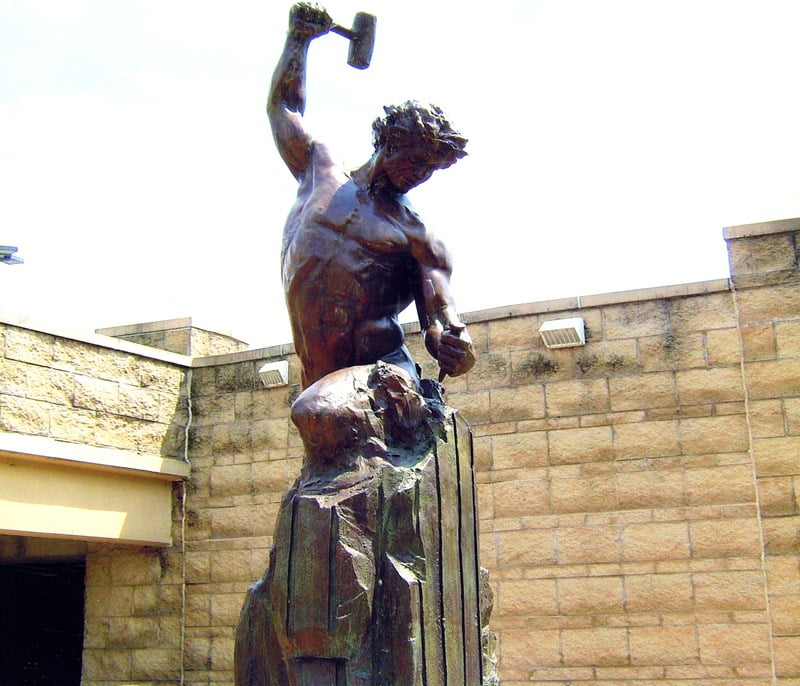 Self Made Man bronze statue installed in a grand villa entrance hall -- placement inspiration.