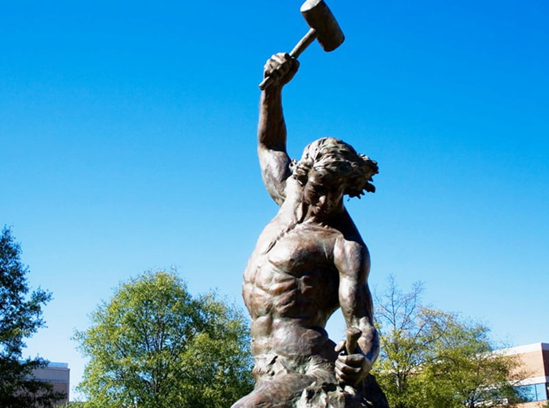 Self Made Man statue overview -- blog feature image showing the sculpture in a gallery setting