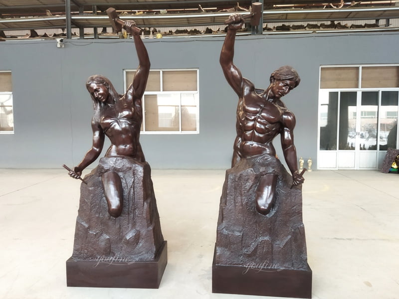 Artisan applying hand-painted patina and coloring to Self-Made Man bronze statue