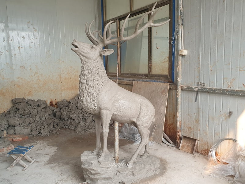 Master sculptor creating clay elk model in Quyang workshop