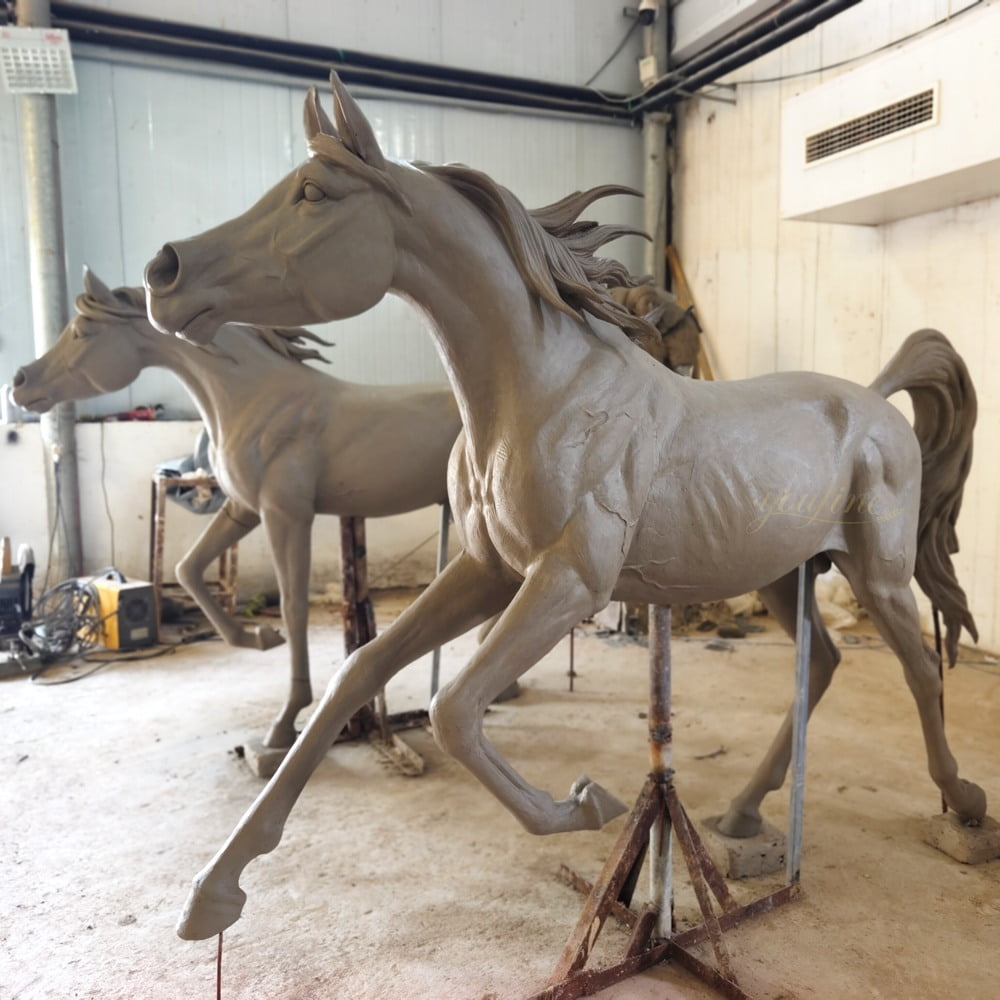 Clay model sculpting process for Dubai Arabian horse - master artisan shaping detailed musculature