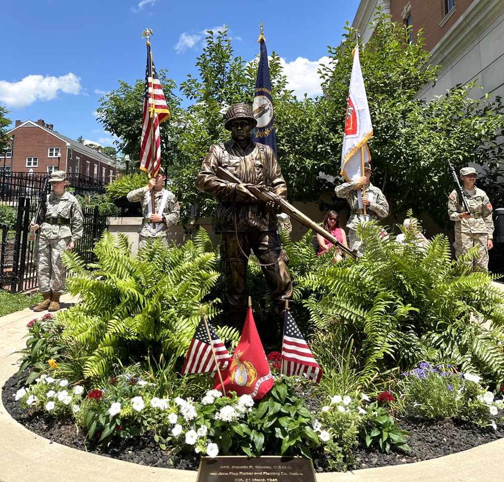 Bronze saluting soldier with flag statue