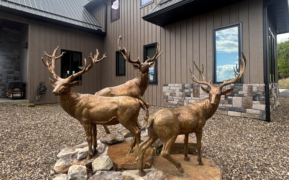 Bronze elk statue in landscape setting