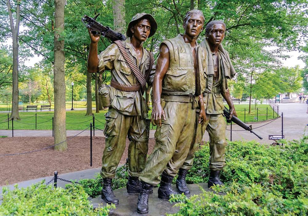 Bronze veteran monument in public park setting