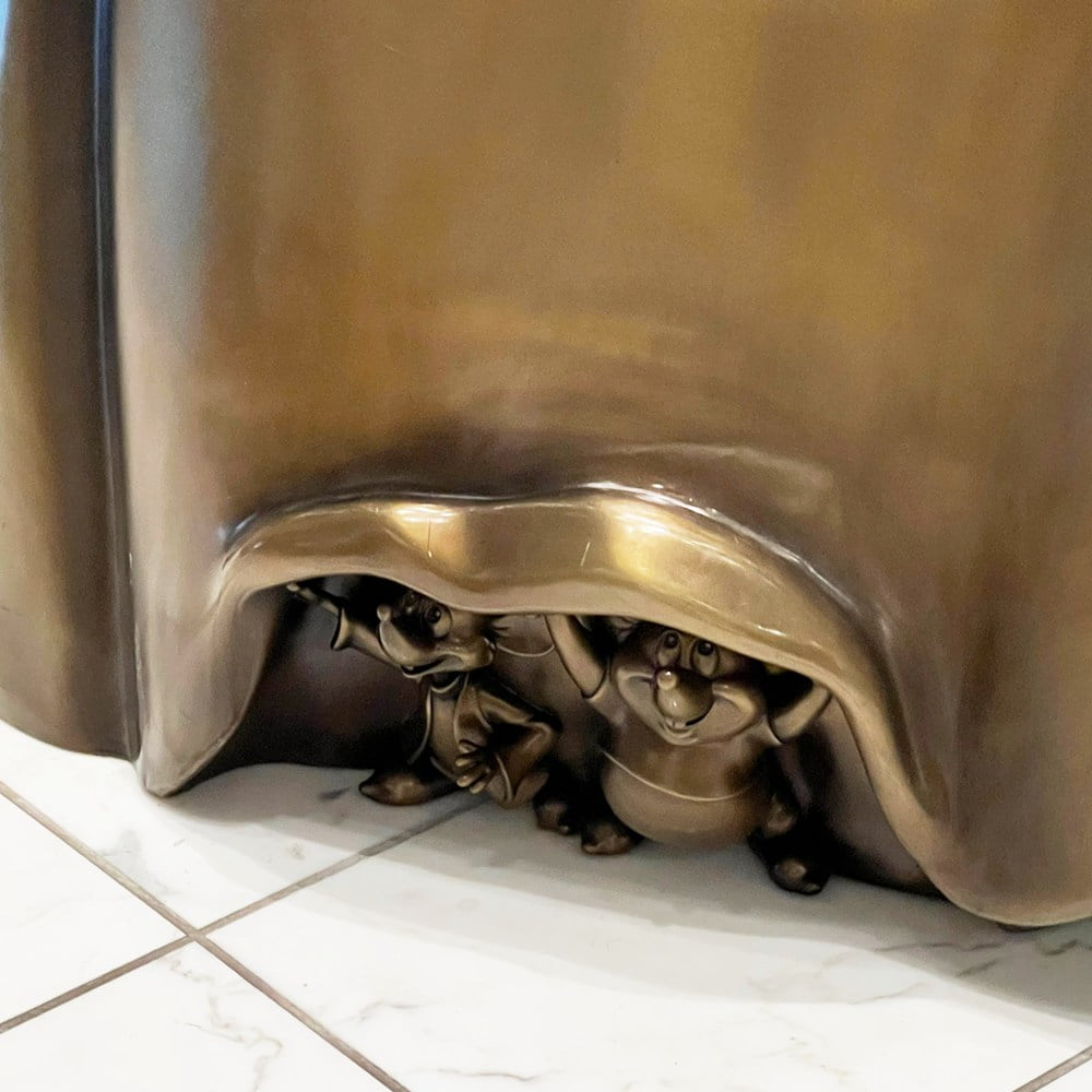 Close‑Up Detail of Hidden Mice Figures Under Skirt of Bronze Cinderella Sculpture