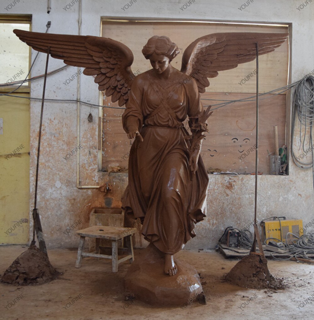 Wide-winged angel clay model in the workshop.