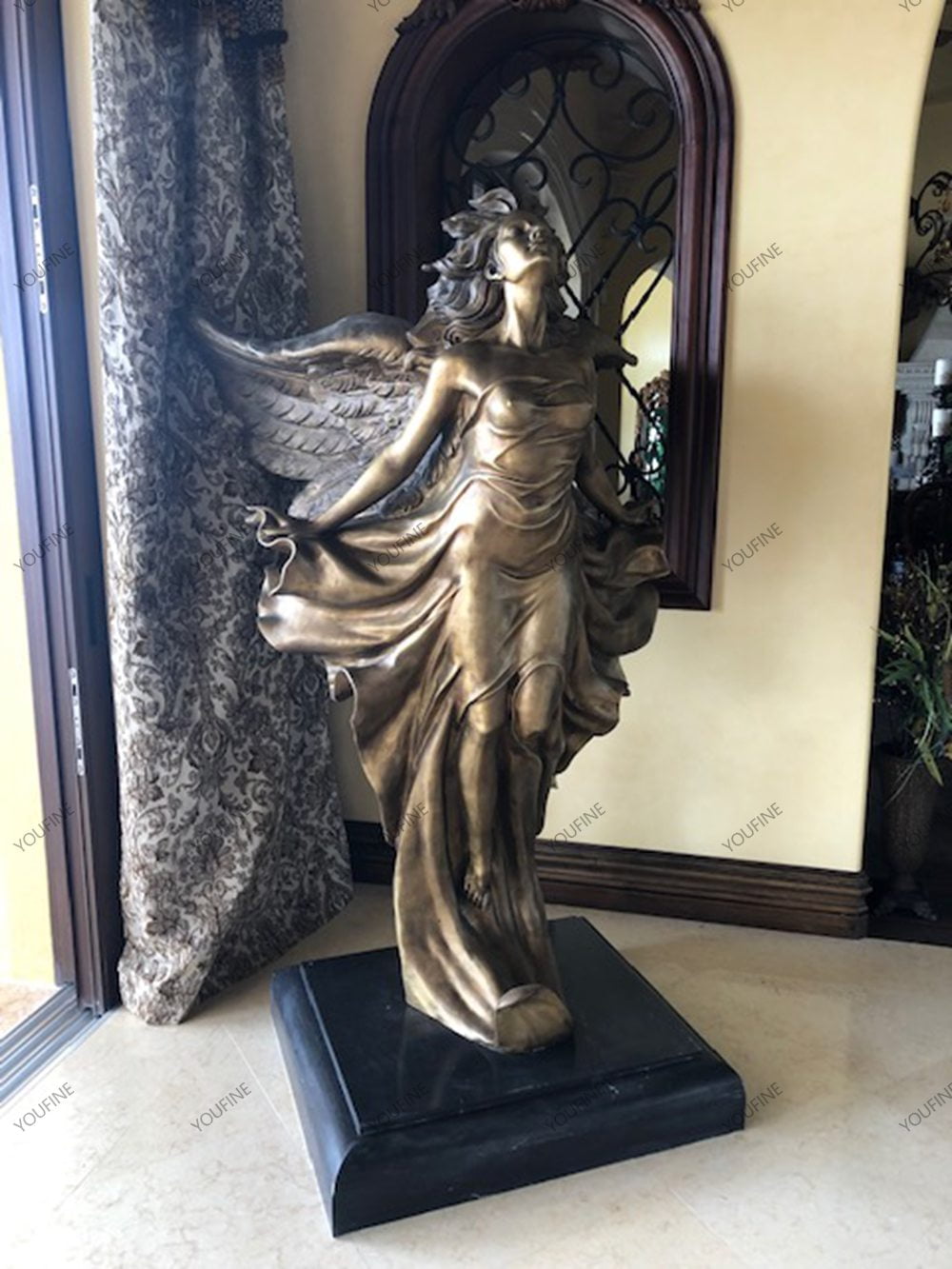Bronze angel sculpture displayed inside a home