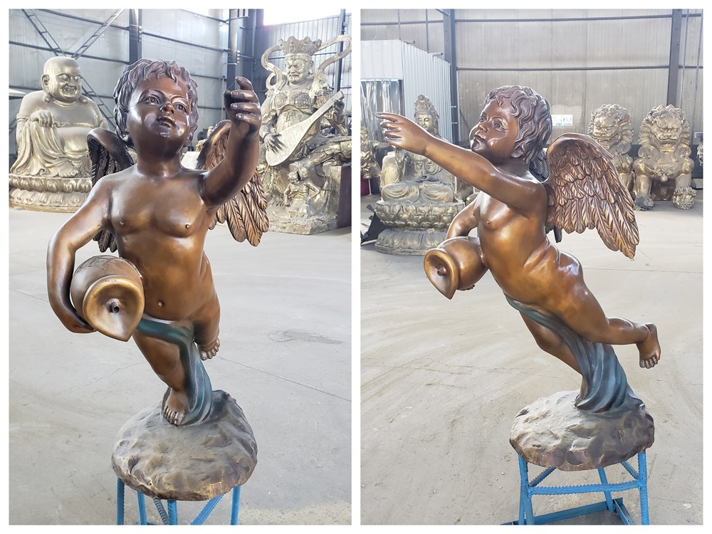Front and side views of a flying bronze cherub statue in the foundry