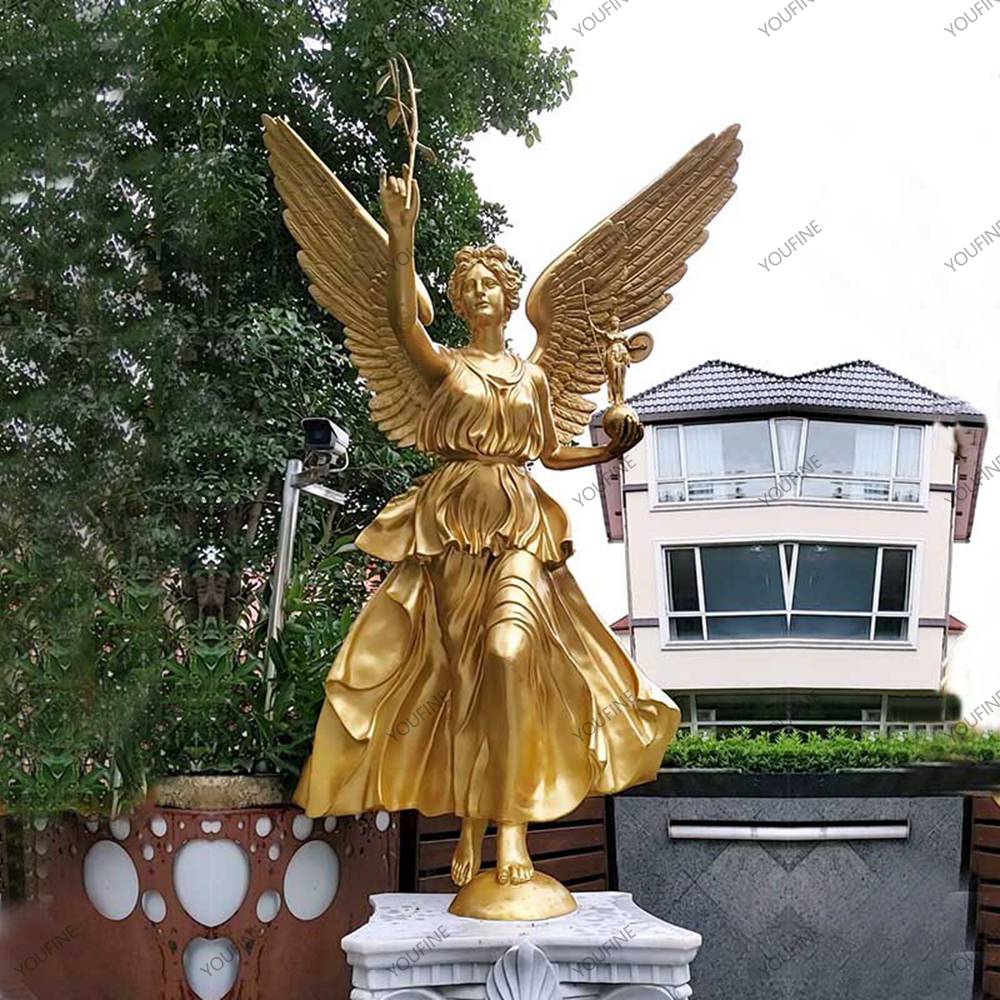 Golden bronze angel statue installed on an outdoor pedestal